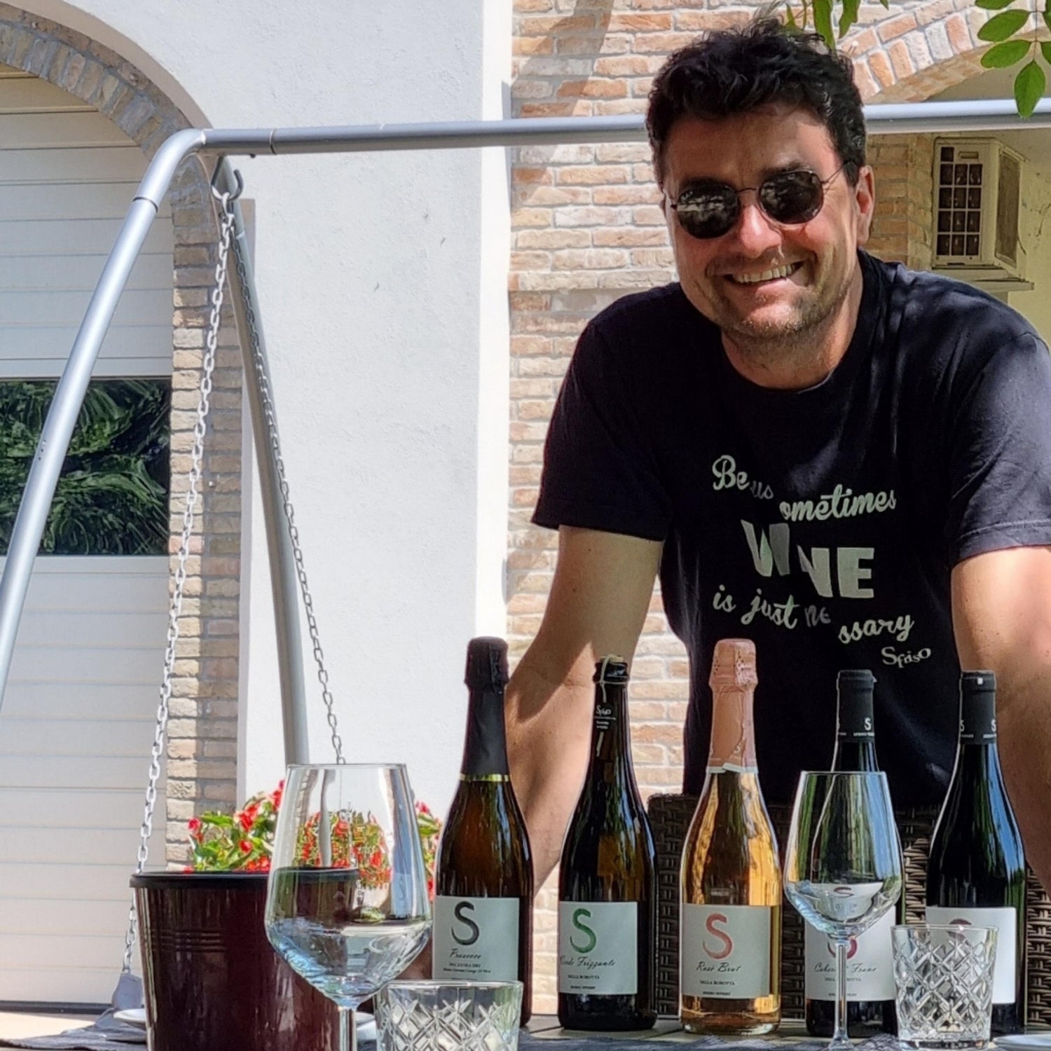 Pier Sfriso standing with the wine bottles in front of him on the tasting table